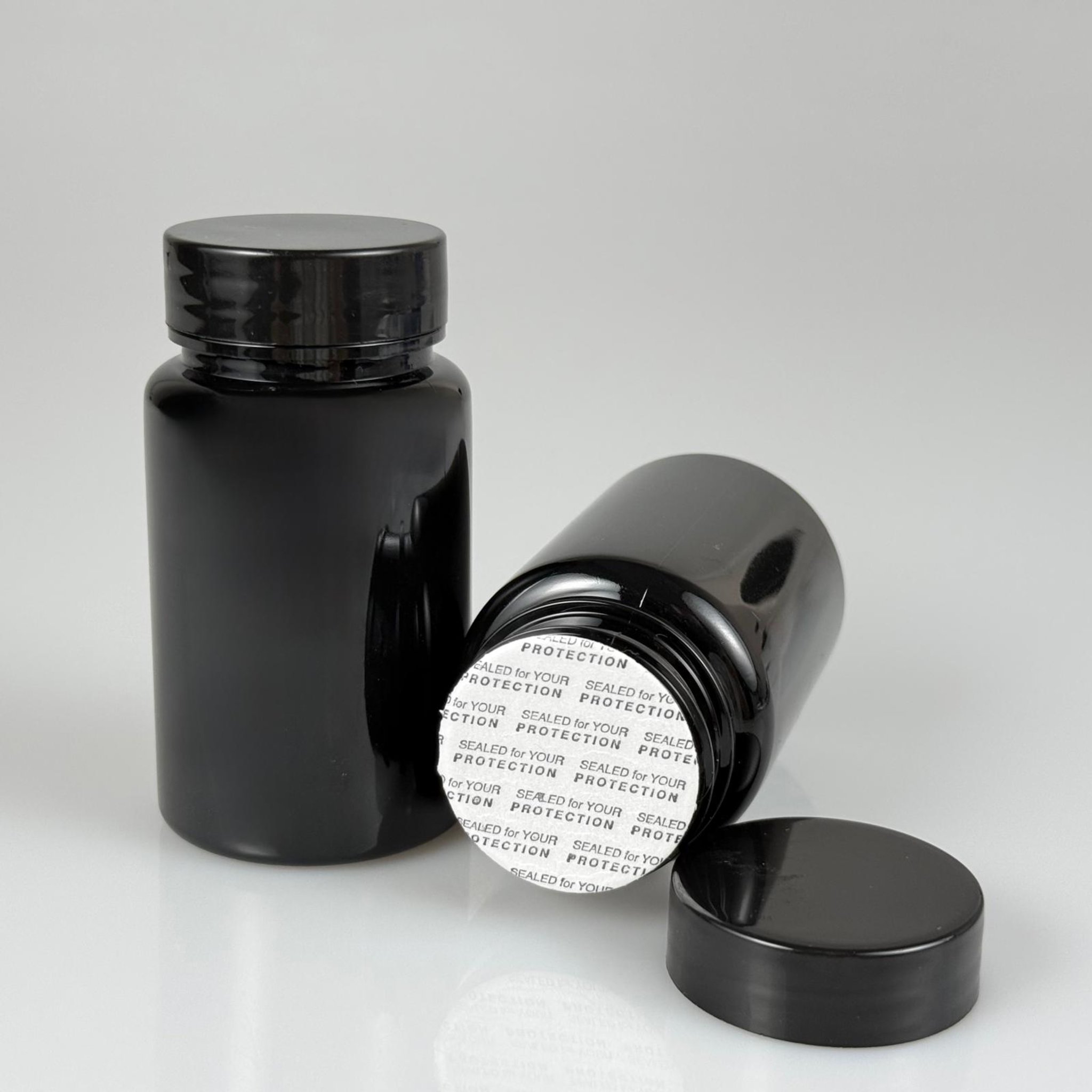 100 CC SİYAH PET TABLET ŞİŞESİ - SİYAH KAPAKLI + KENDİNDEN YAPIŞKANLI KÖPÜK CONTALI - 100 ML KAPSÜL KUTUSU - İLAÇ ŞİŞESİ - MEDİKAL HAP ŞİŞESİ - FARMASÖTİK KAVANOZ