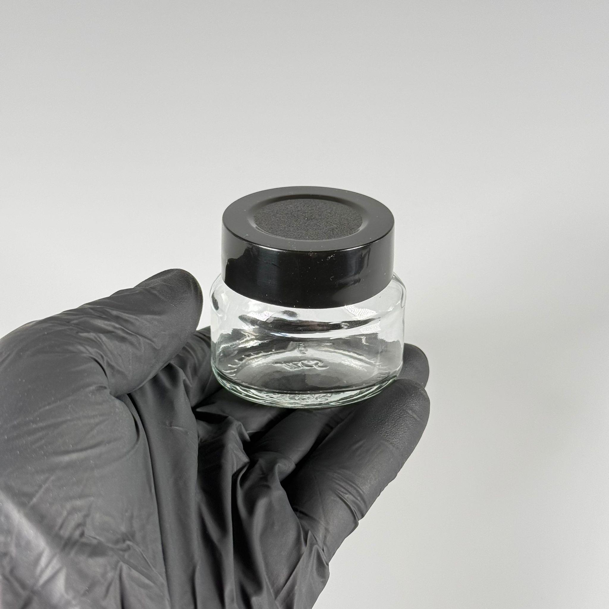 40 CC ELİPS OVAL CAM KAVANOZ - SİYAH PLASTİK DERİN ÜSTÜ KUMLAMA KAPAKLI + KENDİNDEN YAPIŞKANLI KÖPÜK CONTALI - 40 ML MİNİ KREM  CAM KAVANOZLARI