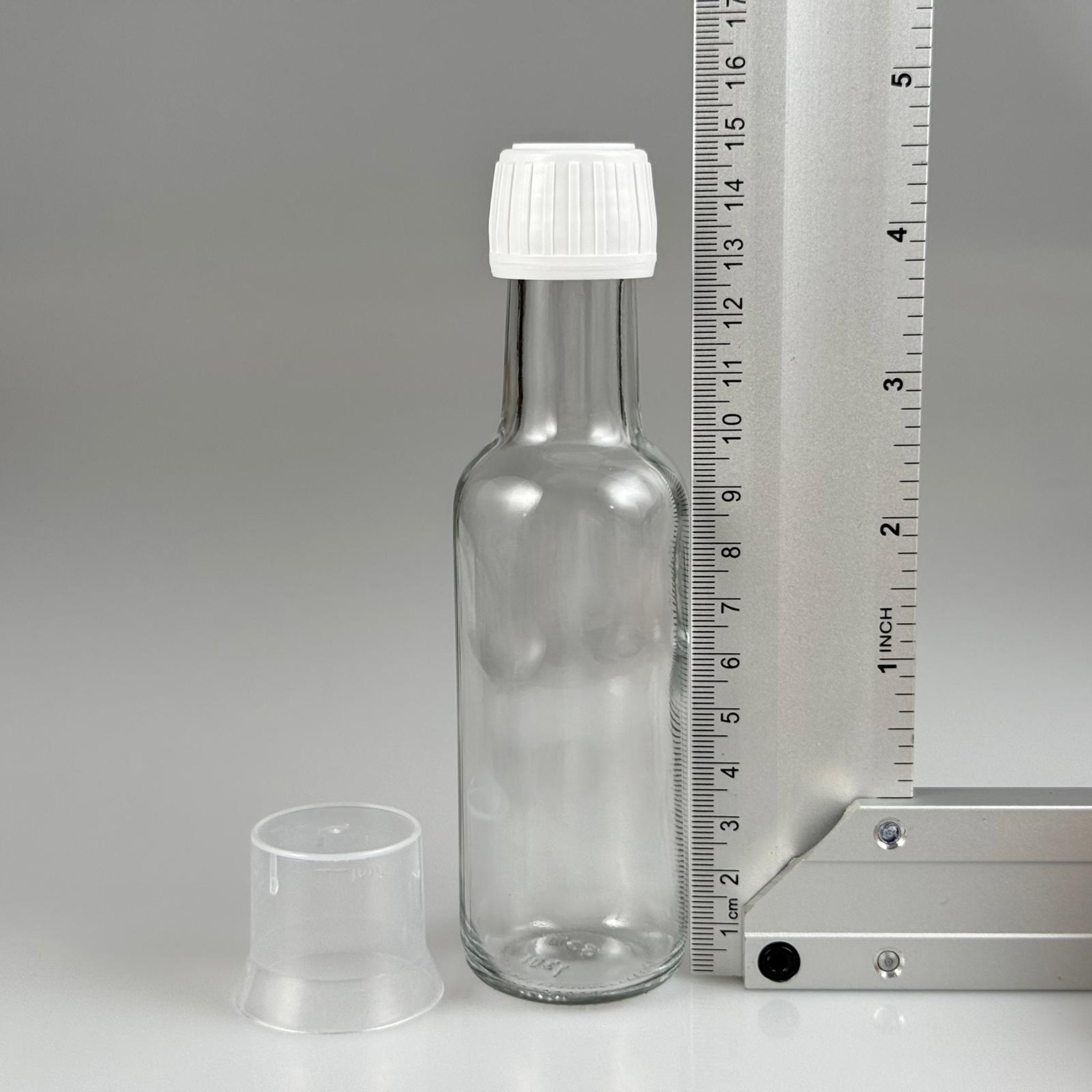 100 CC DORİKA CAM ŞİŞE + BEYAZ KİLİTLİ KAPAK+ 15 ML ÖLÇEK TAKIM - 100 ML ŞEFFAF CAM DORİKA ŞİŞE