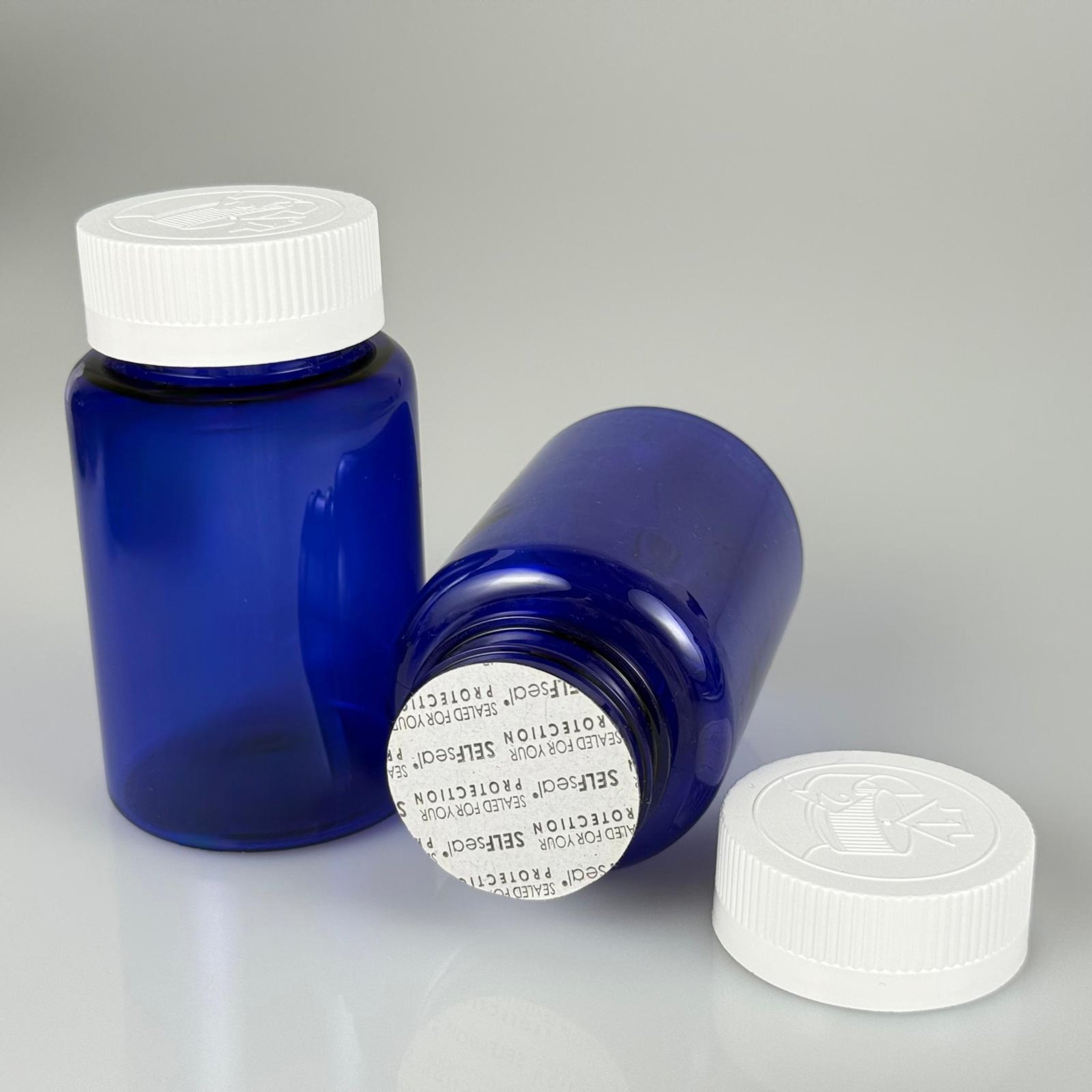 150 ML CONTALI ÇOCUK KİLİT KAPAKLI TABLET ŞİŞESİ  - 150 CC MAVİ PET KAVANOZ + 38 MM BEYAZ ÇOCUK KİLİTLİ KAPAK + KENDİNDEN YAPIŞKANLI KÖPÜK CONTA TAKIM -  KAPSÜL KUTUSU - İLAÇ ŞİŞESİ - MEDİKAL HAP ŞİŞESİ - FARMASÖTİK KAVANOZ