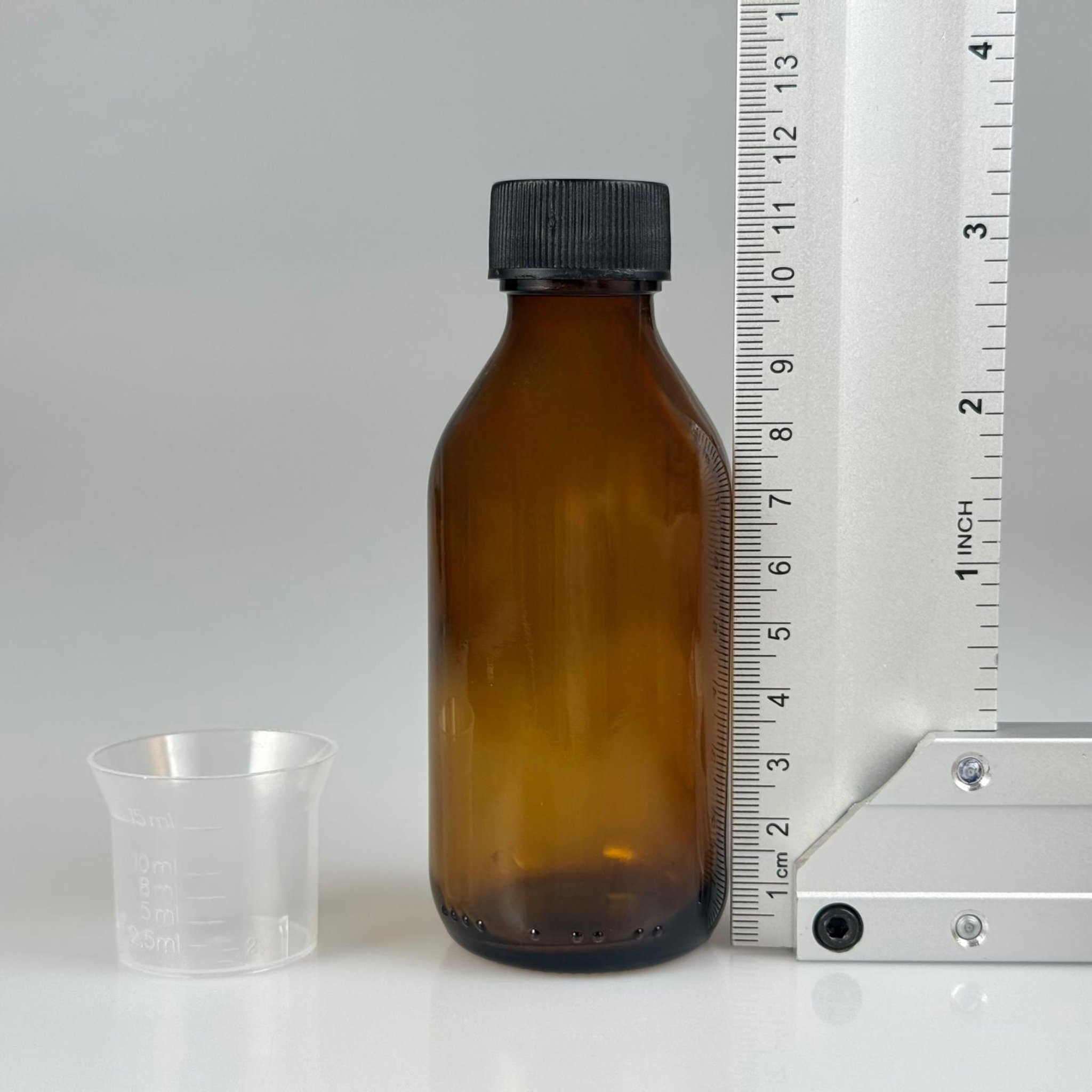 100 CC AMBER CAM ŞİŞE + SİYAH PLASTİK KAPAK + 15 ML ÖLÇEK TAKIM - 100 ML KAHVERENGİ BOŞ ŞURUP ŞİŞESİ (AĞIZ ÇAPI 25 MM)