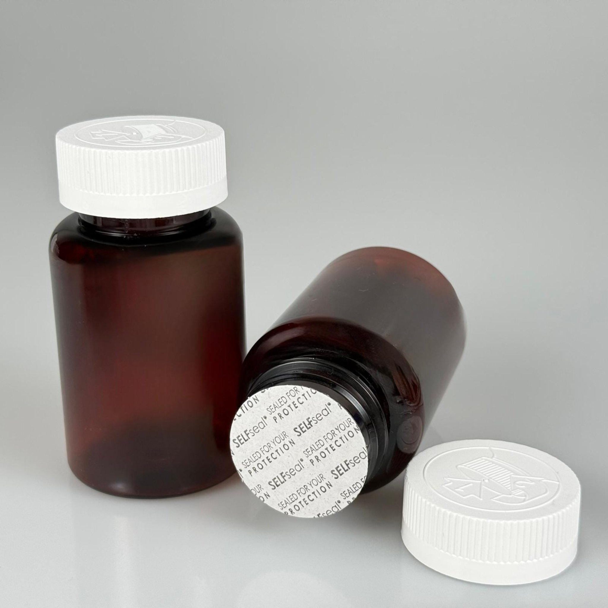 150 ML CONTALI ÇOCUK KİLİT KAPAKLI TABLET ŞİŞESİ  - 150 CC AMBER PET KAVANOZ + 38 MM BEYAZ ÇOCUK KİLİTLİ KAPAK + KENDİNDEN YAPIŞKANLI KÖPÜK CONTA TAKIM -  KAPSÜL KUTUSU - İLAÇ ŞİŞESİ - MEDİKAL HAP ŞİŞESİ - FARMASÖTİK KAVANOZ