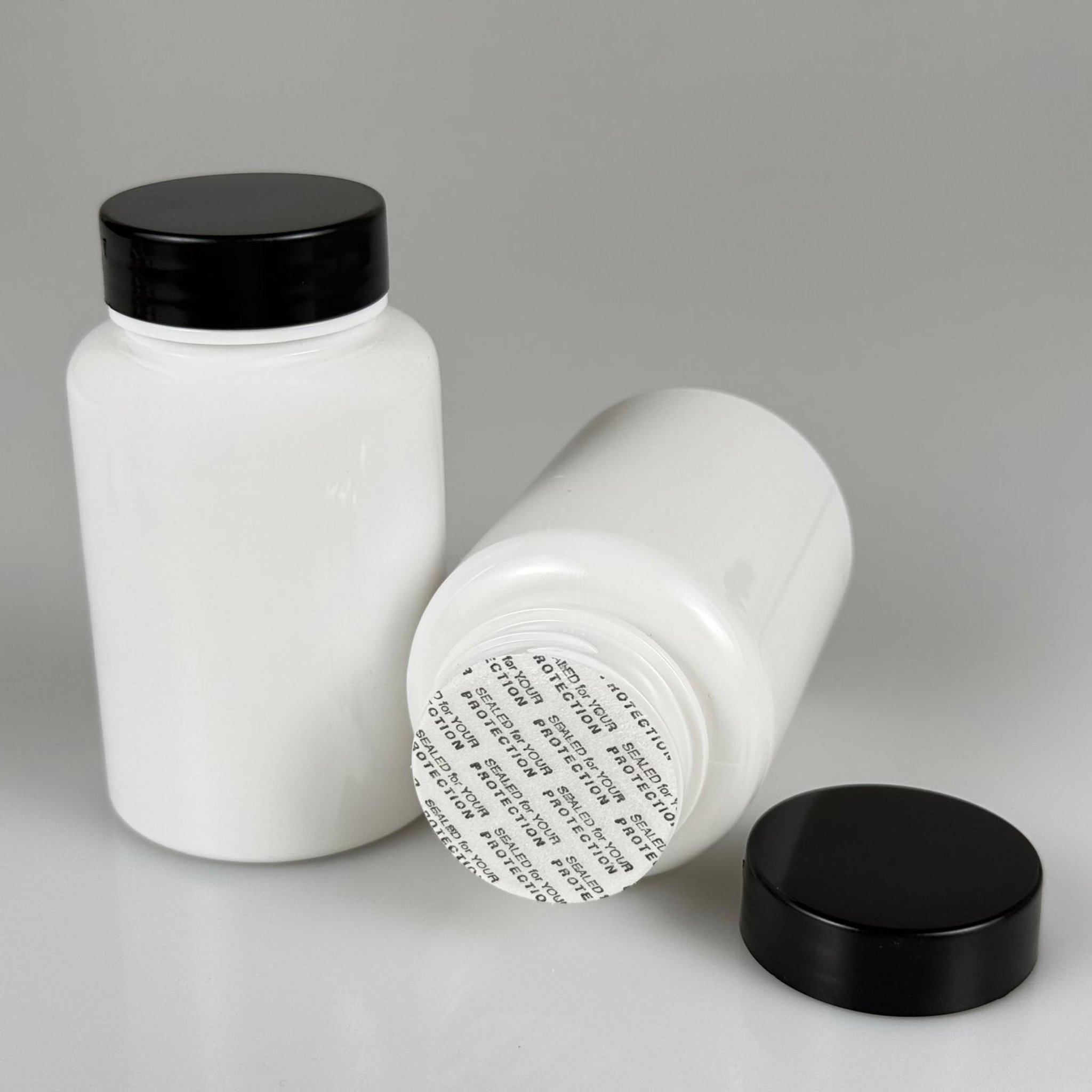 150 CC BEYAZ PET TABLET ŞİŞESİ - SİYAH KAPAKLI + KENDİNDEN YAPIŞKANLI KÖPÜK CONTALI - 150 ML KAPSÜL KUTUSU - İLAÇ ŞİŞESİ - MEDİKAL HAP ŞİŞESİ - FARMASÖTİK KAVANOZ