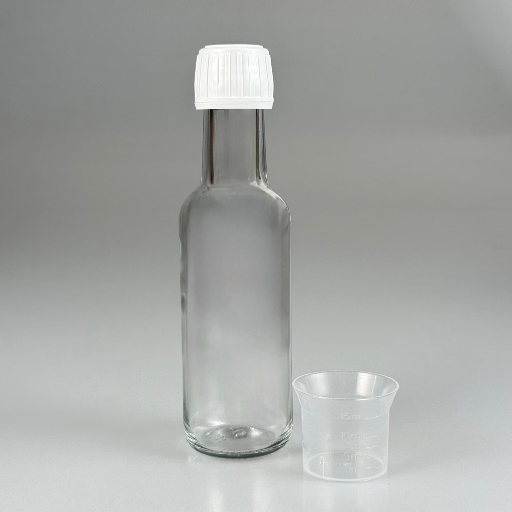 100 CC DORİKA CAM ŞİŞE + BEYAZ KİLİTLİ KAPAK+ 15 ML ÖLÇEK TAKIM - 100 ML ŞEFFAF CAM DORİKA ŞİŞE