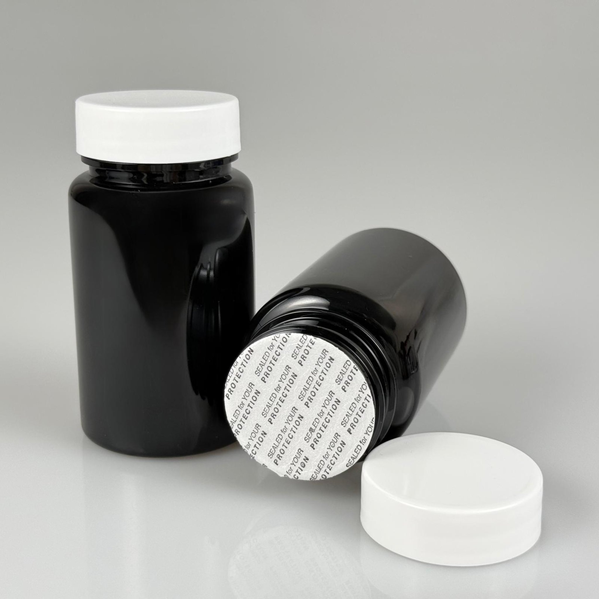 100 CC SİYAH PET TABLET ŞİŞESİ - BEYAZ KAPAKLI + KENDİNDEN YAPIŞKANLI KÖPÜK CONTALI - 100 ML KAPSÜL KUTUSU - İLAÇ ŞİŞESİ - MEDİKAL HAP ŞİŞESİ - FARMASÖTİK KAVANOZ
