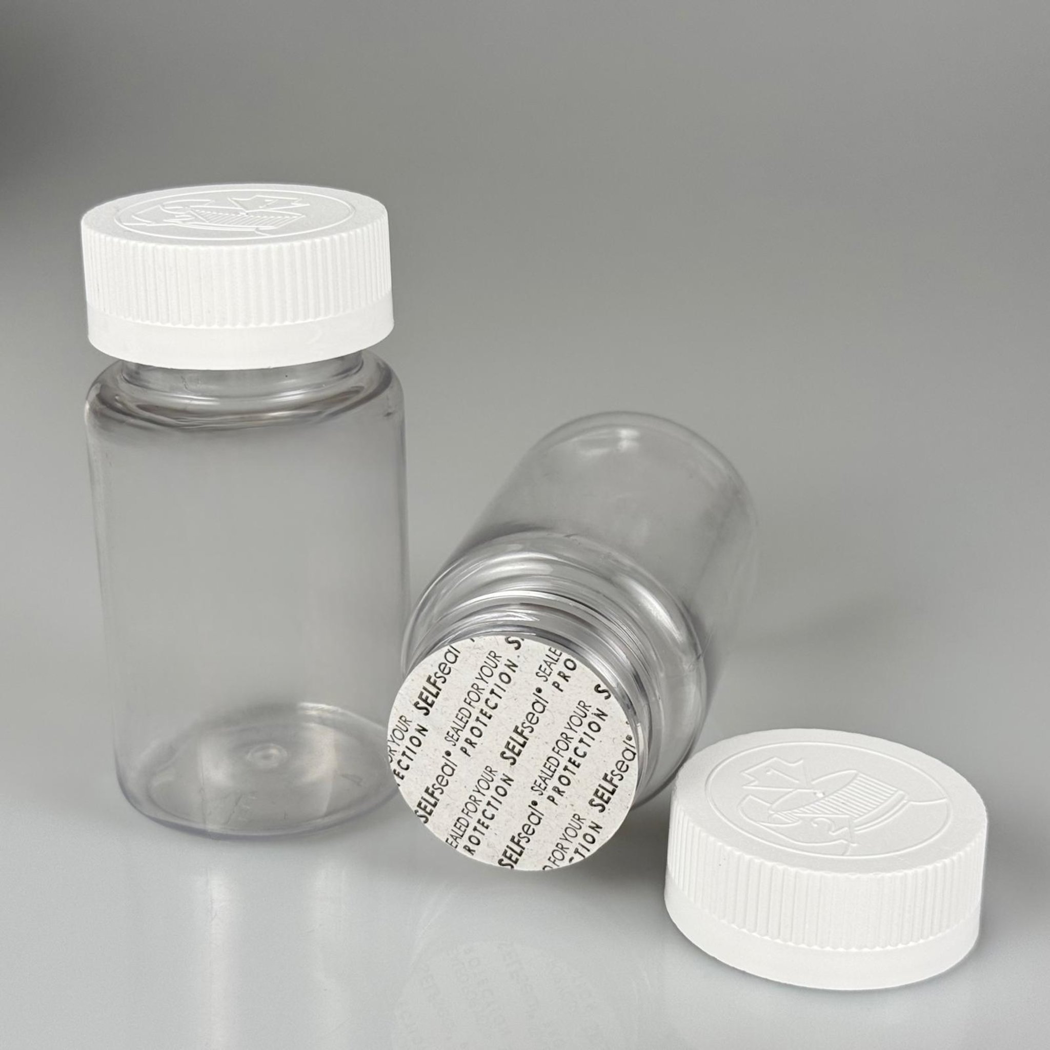 100 ML CONTALI ÇOCUK KİLİT KAPAKLI TABLET ŞİŞESİ  - 100 CC ŞEFFAF PET KAVANOZ + 38 MM BEYAZ ÇOCUK KİLİTLİ KAPAK + KENDİNDEN YAPIŞKANLI KÖPÜK CONTA TAKIM -  KAPSÜL KUTUSU - İLAÇ ŞİŞESİ - MEDİKAL HAP ŞİŞESİ - FARMASÖTİK KAVANOZ