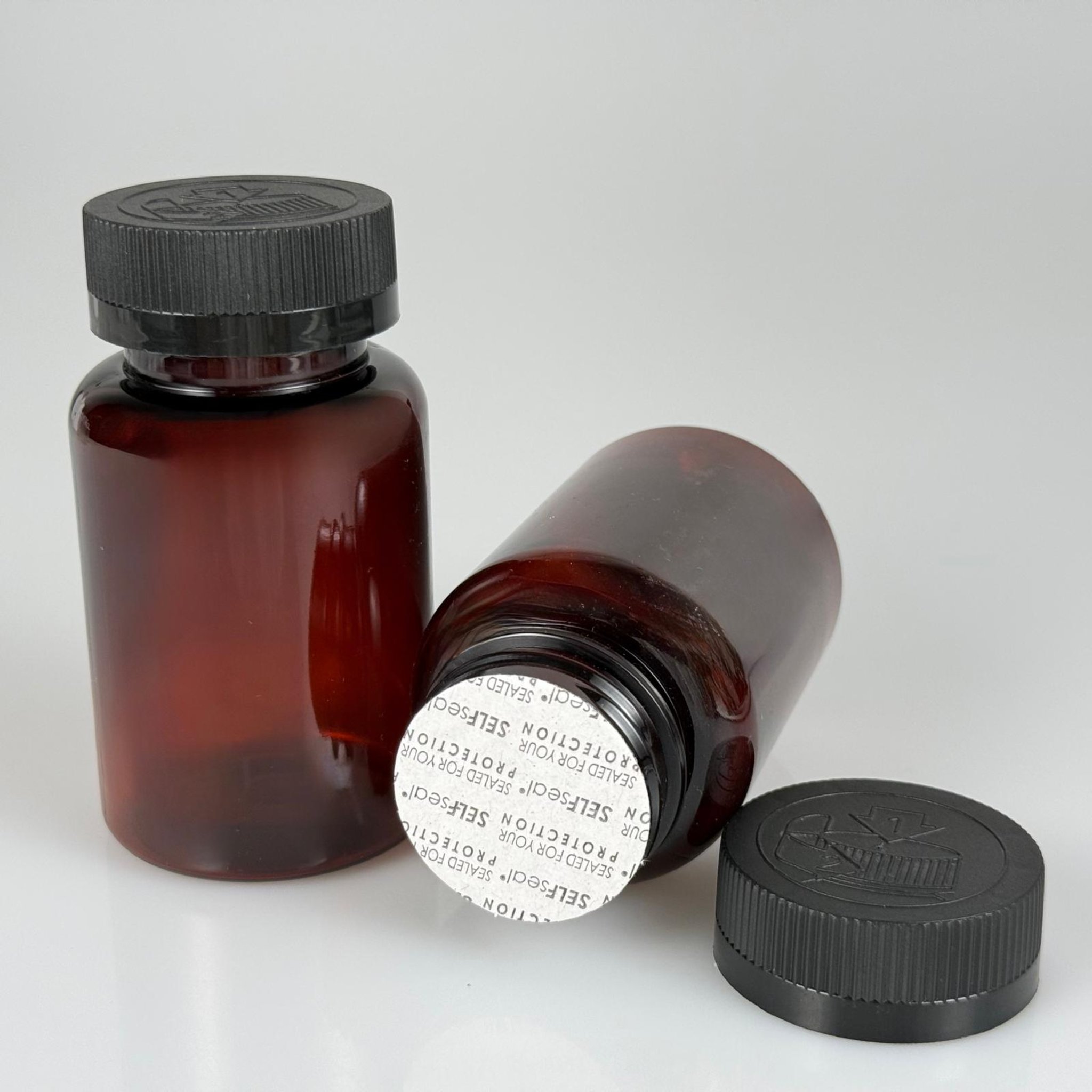 150 ML CONTALI ÇOCUK KİLİT KAPAKLI TABLET ŞİŞESİ  - 150 CC AMBER PET KAVANOZ + 38 MM SİYAH ÇOCUK KİLİTLİ KAPAK + KENDİNDEN YAPIŞKANLI KÖPÜK CONTA TAKIM -  KAPSÜL KUTUSU - İLAÇ ŞİŞESİ - MEDİKAL HAP ŞİŞESİ - FARMASÖTİK KAVANOZ